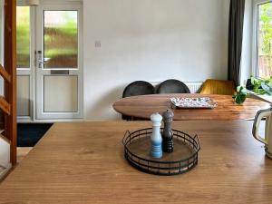 a living room with a table with a chessetts at Views Wood in Uckfield