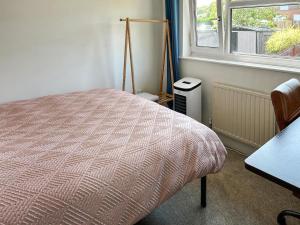 a bedroom with a bed and a window at Views Wood in Uckfield +4 photos
