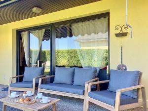 two chairs and a coffee table on a patio at Holiday Home Dorenavant by Interhome in Bouveret