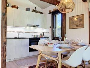 a kitchen with a table and chairs in a kitchen at Holiday Home Dorenavant by Interhome in Bouveret
