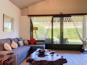 a living room with a couch and a table at Holiday Home Dorenavant by Interhome in Bouveret +20 photos