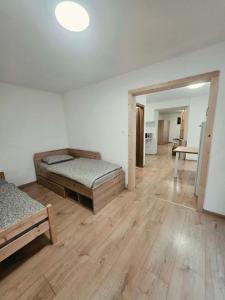 a large room with two beds and a hallway at Apartmán Gabriel in Kežmarok