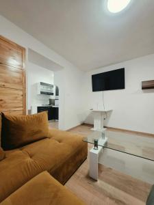 a living room with a couch and a flat screen tv at Apartmán Gabriel in Kežmarok