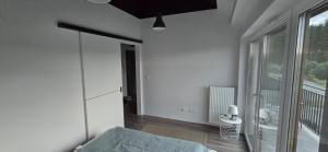 a bedroom with a bed and a large window at Villa nad stawem in Pszczew +2 photos