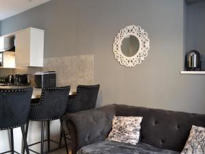 a living room with a couch and a table at Doodles Holiday Home in Eyemouth