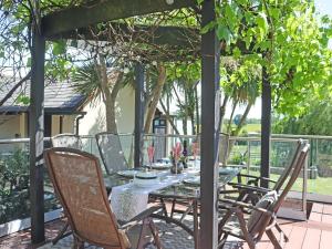 a table and chairs sitting on a patio with a table and chairs at Deerview Lodge - Uk51044 in Bonvilston