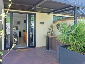 a patio with a sliding glass door and plants at Deerview Lodge - Uk51044 in Bonvilston