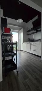 a room with a kitchen with a chair in it at Villa nad stawem in Pszczew