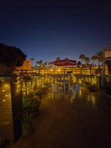 a patio with white chairs and lights at night at Morocco AG in Casablanca