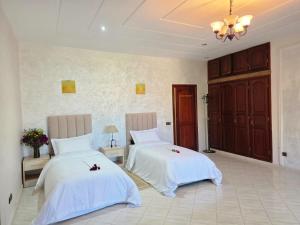 two beds with white sheets in a room at Morocco AG in Casablanca