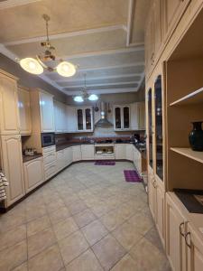 a large kitchen with white cabinets and a tile floor at Morocco AG in Casablanca