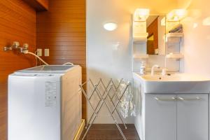 a bathroom with a sink and a washing machine at ベルビー川崎 in Kawasaki