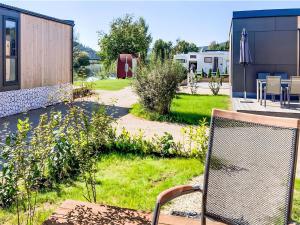 a chair sitting on a patio in a yard at Holiday Home Tiny Haus Altmühlblick Nr- 83 by Interhome in Beilngries