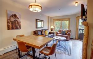 a living room with a wooden table and chairs at CS221 Copper Springs in Copper Mountain