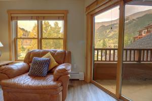 a leather chair in a living room with a large window at CS221 Copper Springs in Copper Mountain