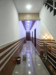 a hallway of a building with purple lights on the floor at Priya Dham in Govardhan