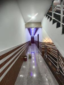 an empty hallway in a building with a blue ceiling at Priya Dham in Govardhan +1 photo