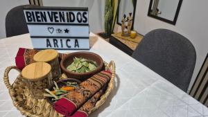 a basket of food on a table with a sign at Milagro Andino in Arica