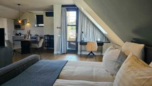 a bedroom with a bed and a living room at Guest Room Utrecht in Utrecht