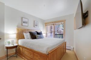 a bedroom with a large bed and a window at CS334 Copper Springs in Copper Mountain