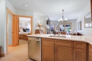 a kitchen with a sink and a living room at CS334 Copper Springs in Copper Mountain
