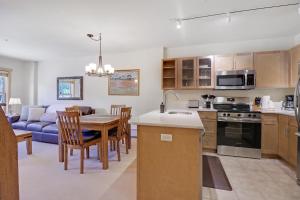 a kitchen and living room with a table and a couch at CS334 Copper Springs in Copper Mountain +31 photos