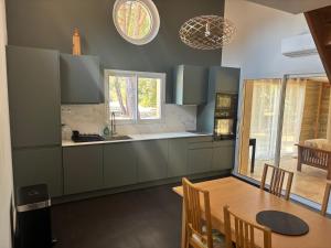 a kitchen with a table and a dining room at Maison récente dans la nature in Roquebrune-sur-Argens +8 photos