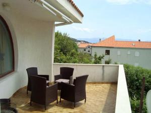 a patio with chairs and a table on a balcony at Apartman Marija Krok in Baška