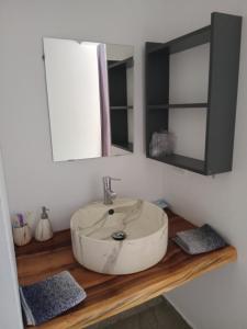 a bathroom with a white sink and a mirror at BUNGALOWS COLIBRI in Las Galeras