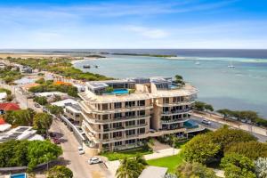 an aerial view of a building next to the ocean at 2 BR Oceanview Condo Coral Shell 3e in Oranjestad