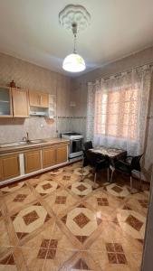 a kitchen with a table and a dining room at Hotel islam 1 in Tlemcen
