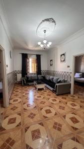 a large living room with a couch and a table at Hotel islam 1 in Tlemcen