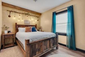 a bedroom with a wooden bed and a window at The Rustic Suite with Hot Tub Romantic Getaway on Main Street in Berlin