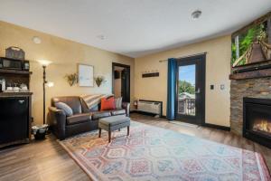 a living room with a couch and a fireplace at The Rustic Suite with Hot Tub Romantic Getaway on Main Street in Berlin