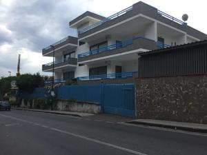 un edificio con una valla azul junto a una calle en Casa Tiziana, en Nápoles