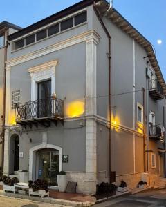 a large gray building with a balcony on a street at Casa Costanza 25 in San Cipirello