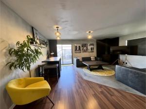 a living room with a yellow chair and a table at Zion Base 3BR Home Backyard Oasis Pets Welcome in St. George +32 photos