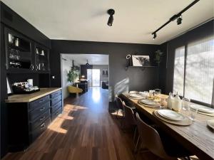 a dining room with a long table and a kitchen at Zion Base 3BR Home Backyard Oasis Pets Welcome in St. George