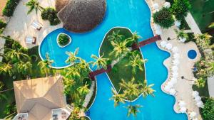 an aerial view of a resort with palm trees and a pool at Wyndham Alltra Punta Cana All Inclusive Resort in Punta Cana