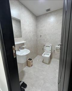a bathroom with a toilet and a sink at Bowsher 501 in Muscat