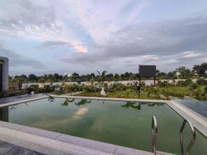 a swimming pool in the middle of a resort at Achala Resorts in Maisaram