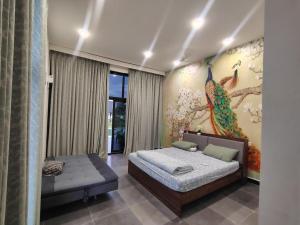 a bedroom with a bed and a peacock painting on the wall at Achala Resorts in Maisaram