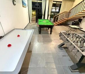 a ping pong table in a room with a pool table at Achala Resorts in Maisaram