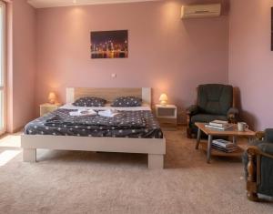 a bedroom with a bed and a couch and a chair at D&D rooms 20 in Pula