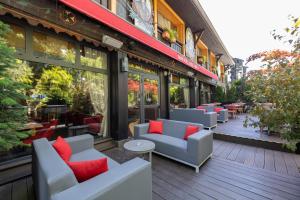a patio with couches and tables on a building at Park Hotel Suisse & Spa in Chamonix