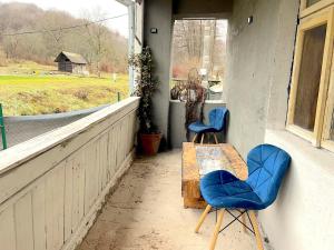 a porch with two chairs and a table and a window at Villa LEA in Ratkovské Bystré