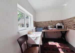 a small kitchen with a table and a microwave at У Катерини in Dvozhets