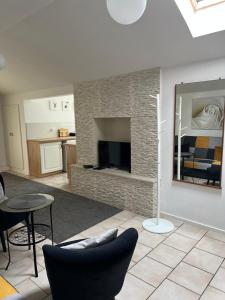 a living room with a fireplace and a tv at Pokoje in Duszniki Zdrój