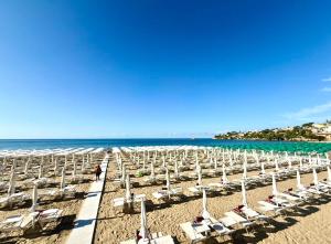 a beach with lounge chairs and the ocean at Nina Guest house in Gaeta