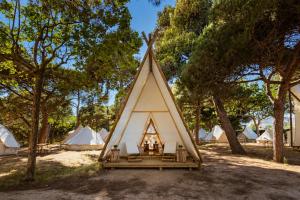 a large white teepee tent with a bunch of tents at Kampaoh Platja d'Aro in Platja d'Aro